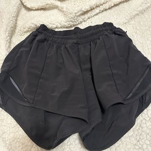 Size 6 black lululemon hotty hot shorts 4”.